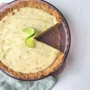 Key Lime Pie on white background with 1 slice cut out