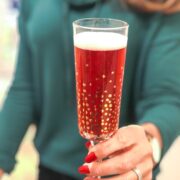 me holding a glass of Cranberry Pomegranate Christmas Punch