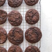 Dark chocolate espresso cookies on white table and cooling rack