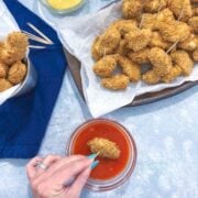 dipping Chicken Bites with Honey Buffalo Dipping Sauce on a blue background