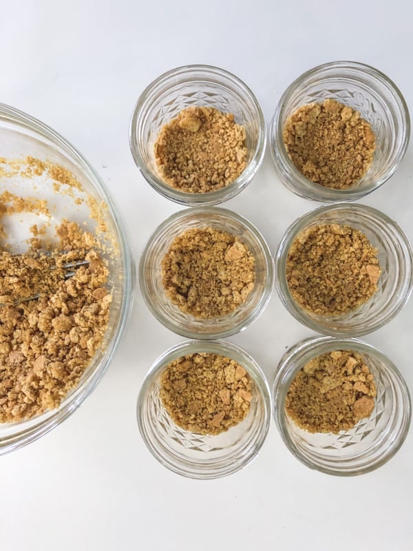 Making graham cracker crust and putting it in mason jars.
