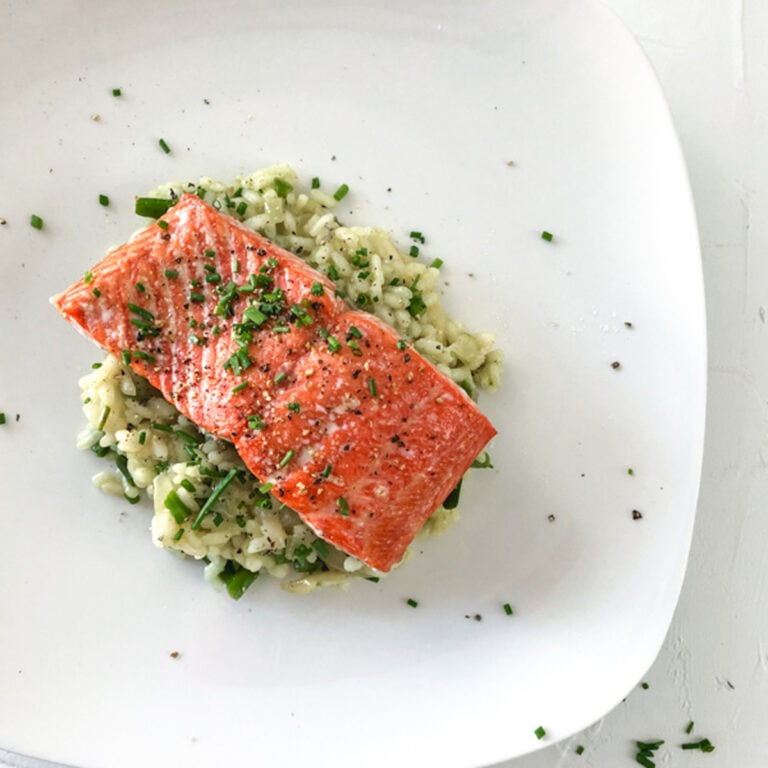 Baked Salmon and Asparagus Risotto on a white plate
