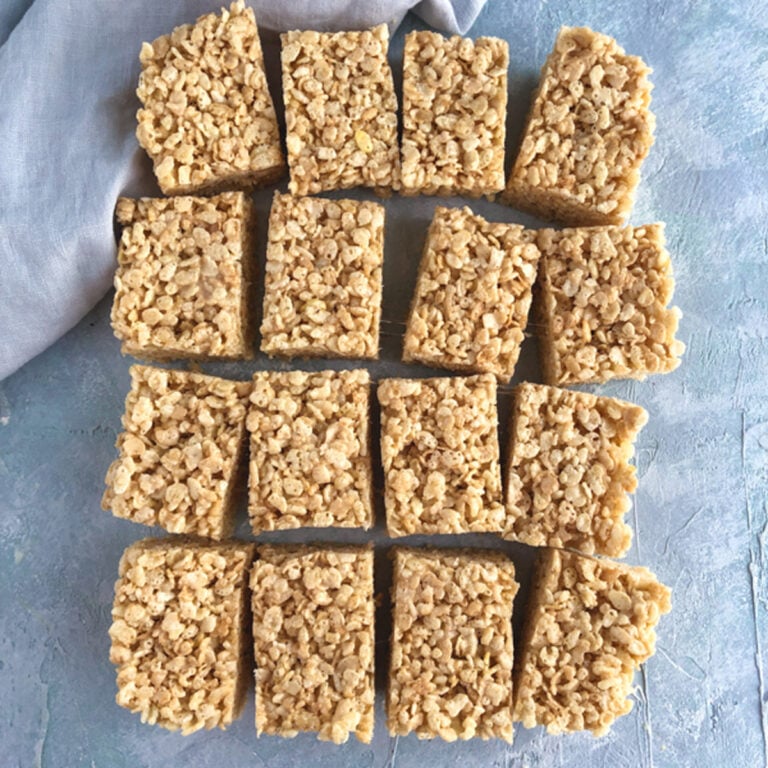 Brown Butter Rice Krispie Treats on a blue background with napkin