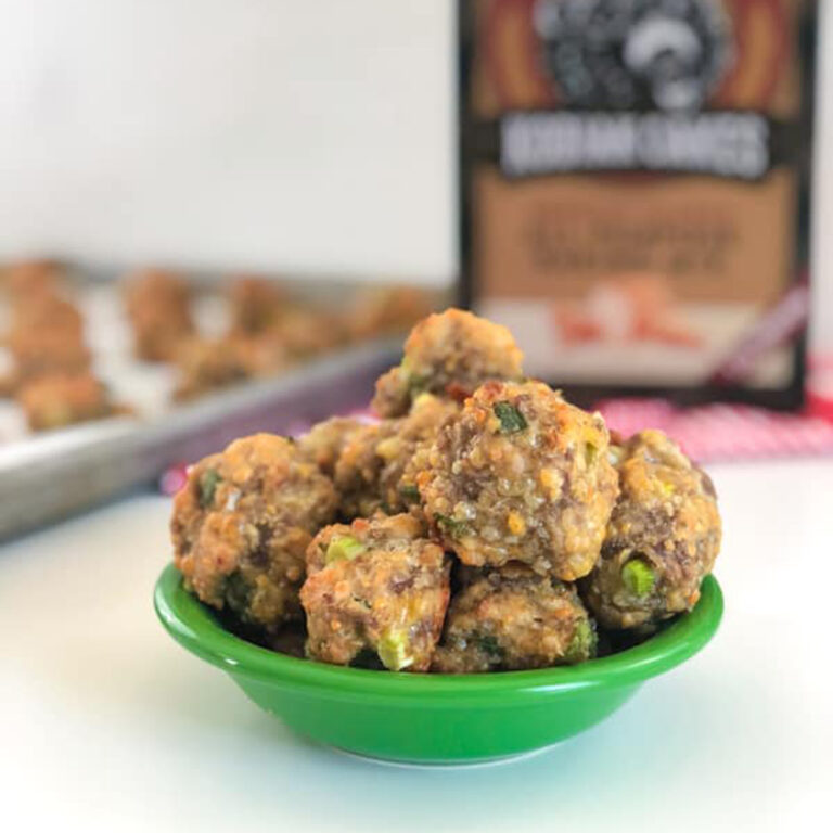 Cheesy Green Onion Sausage Balls in a green bowl with Kodiak Cakes box in background