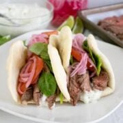 2 sous vide steak gyros on a white plate