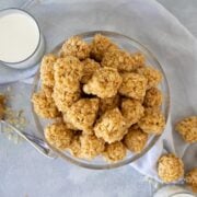 overhead shot of a bowl of peanut butter rice krispie balls and 2 glasses of milk