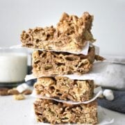 stacked Chocolate Chex Marshmallow Bars with a glass of milk in the background