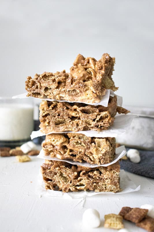 stacked Chocolate Chex Marshmallow Bars with a glass of milk in the background