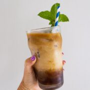me holding a glass of mint cold brew