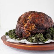 fried turkey on a brown platter with kale around it
