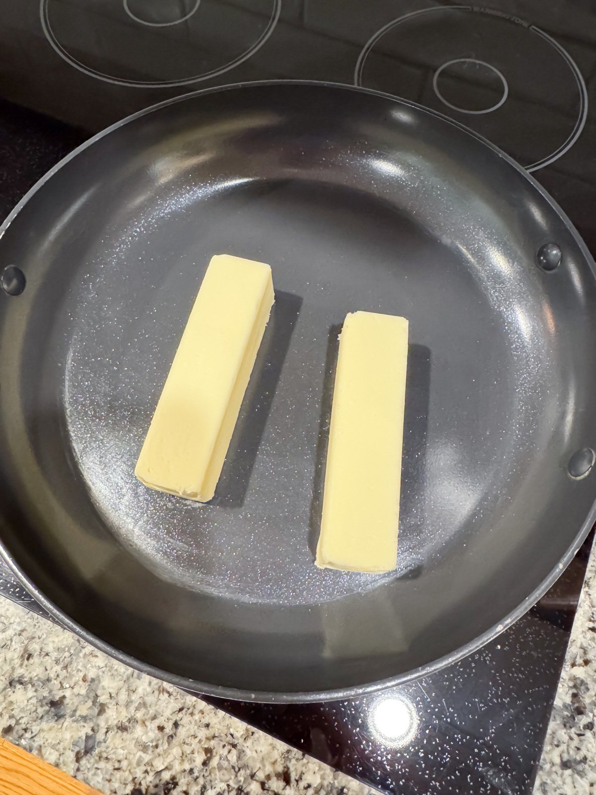 2 sticks of butter in a skillet on the stove.