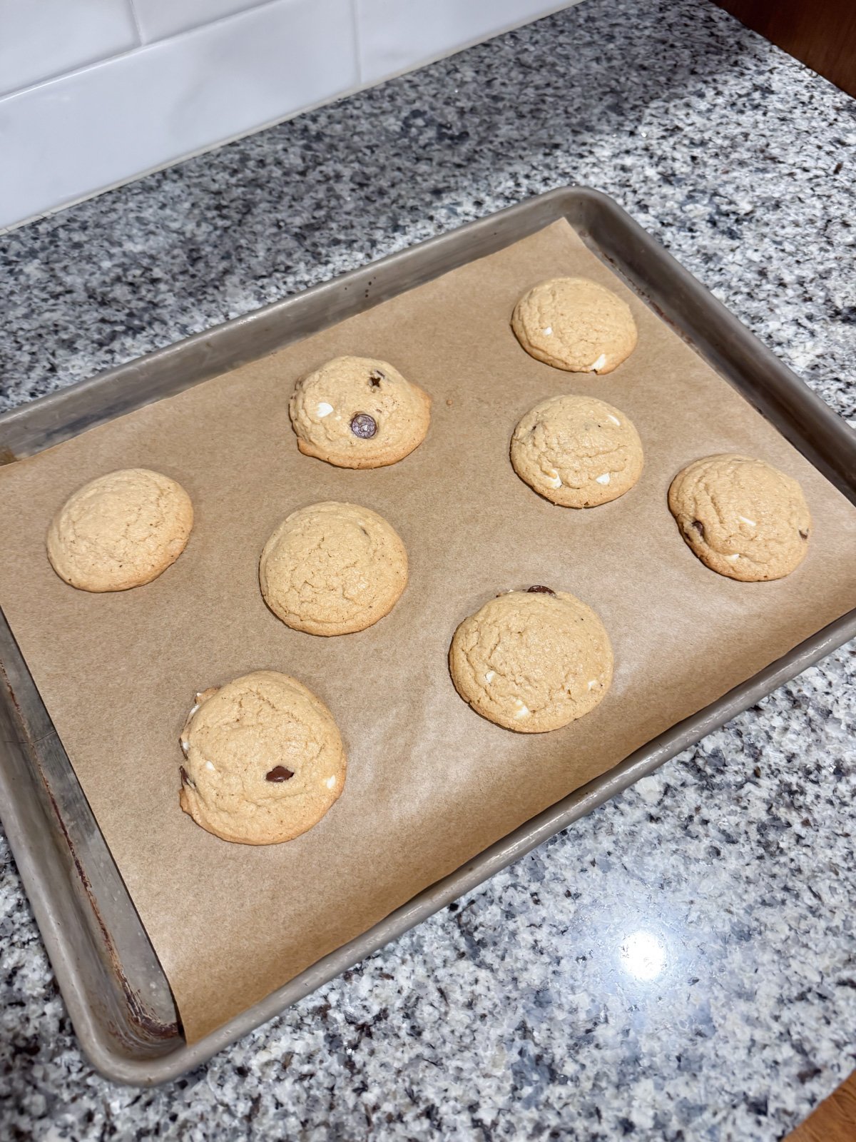 brown butter cookies that have just come out of the oven on a baking sheet. 