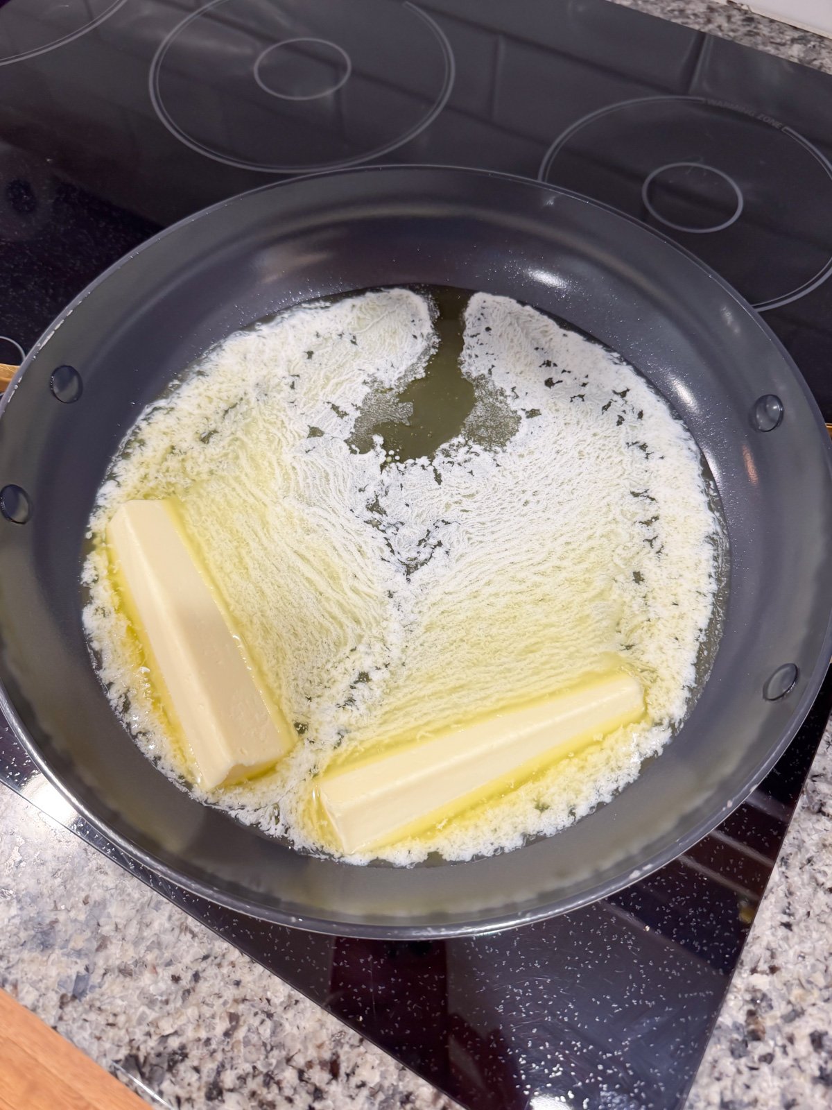 melting 2 sticks of butter on the stove in a large skillet. 