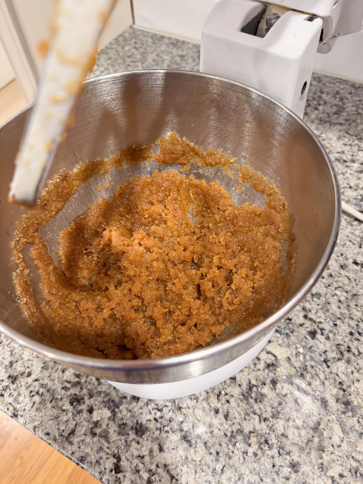 mixing together butter and sugar in a mixing bowl for cookies. 