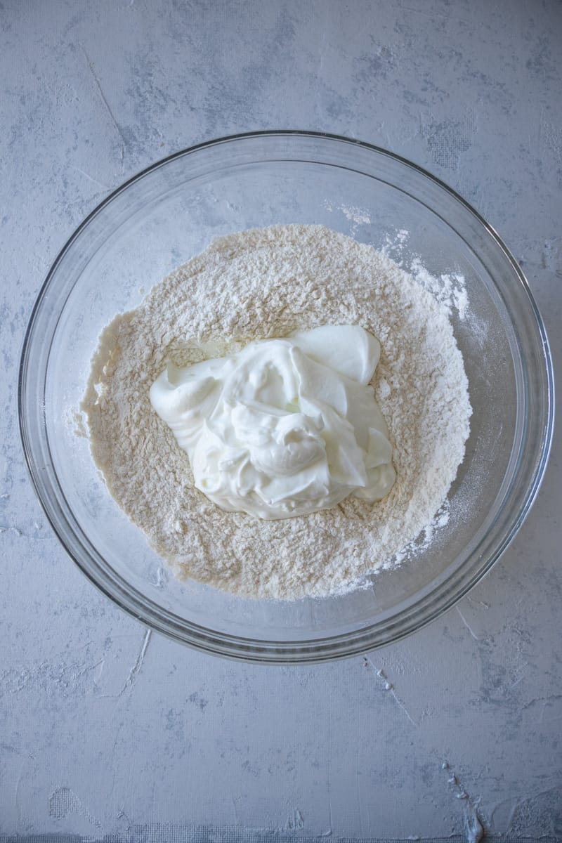 flour and greek yogurt in a large mixing bowl.