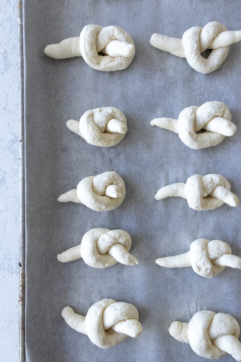 garlic knots on a baking sheet before going into the oven to bake.