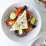 greek salad in 3 white bowls