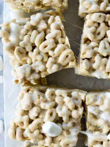 cereal marshmallow bars in a 9x13 pan on a blue surface