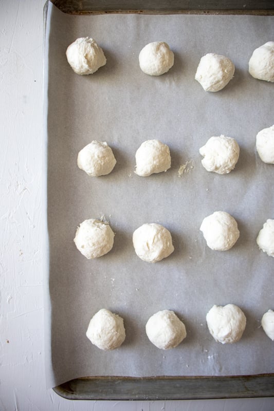 bagel bites on a baking sheet lined with parchment before going into the oven.