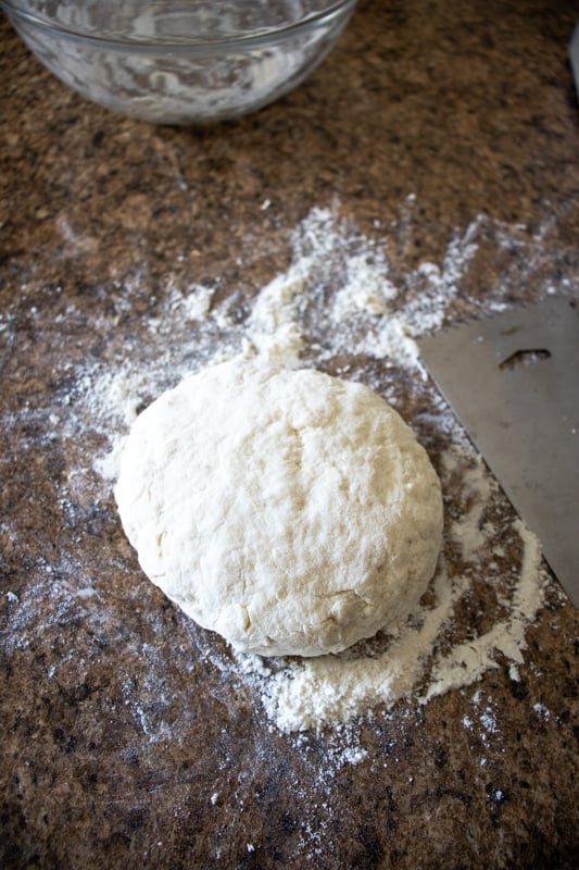 Rolling our dough on a floured counter top.