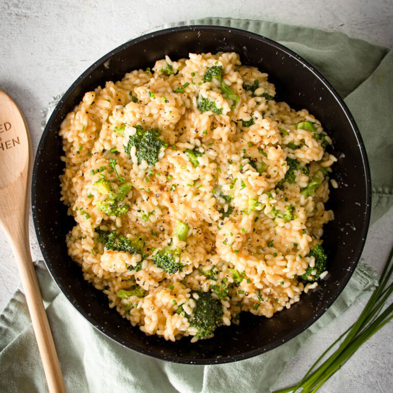 big bowl of Broccoli & Cheddar Risotto with a green napkin behind it
