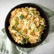 big bowl of Broccoli & Cheddar Risotto with a green napkin behind it