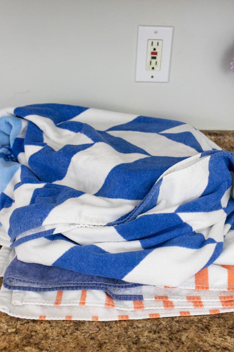 beach towels on a kitchen counter wrapped around mason jars.