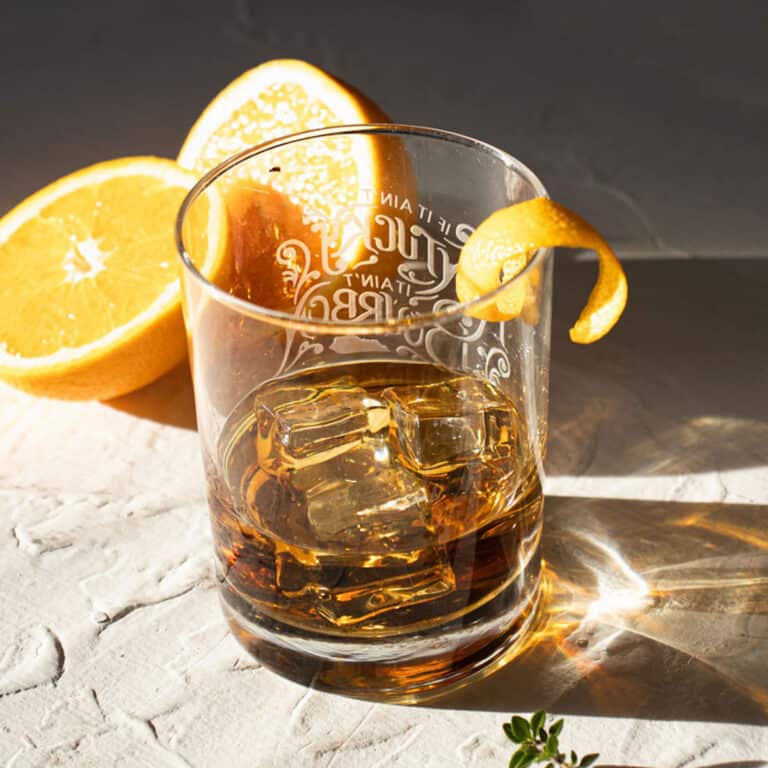 3 high ball glasses of orange and thyme bourbon infusion.