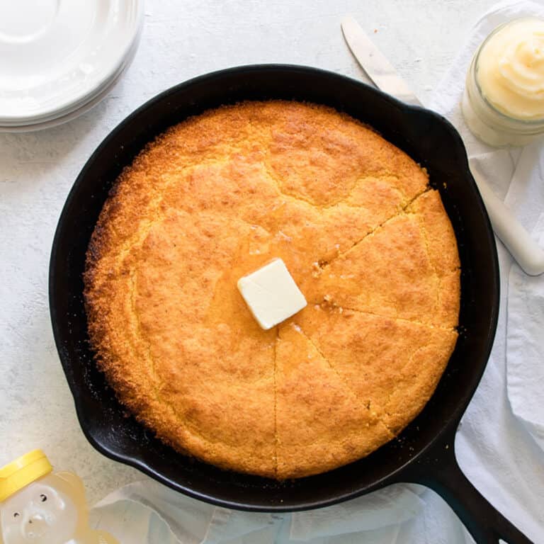 Cast Iron Skillet Cornbread with a pad of butter in the middle