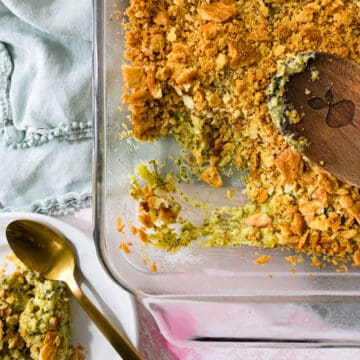 A scoop taken out of a dish of broccoli casserole.