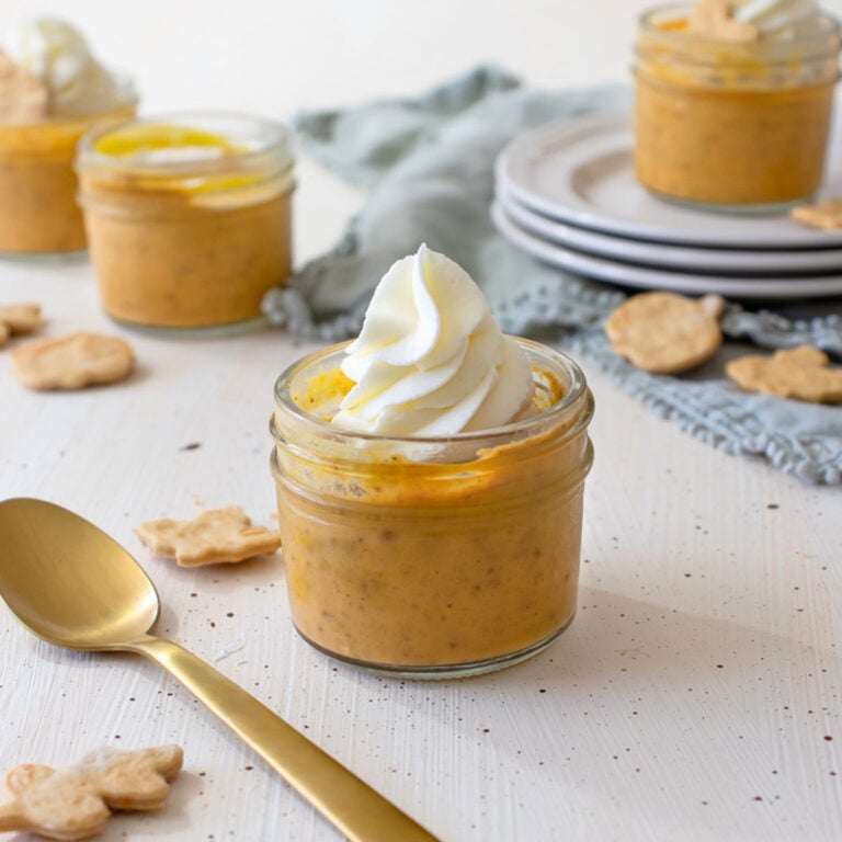 jars of Sous Vide Pumpkin Pie with a spoons and napkin next to it