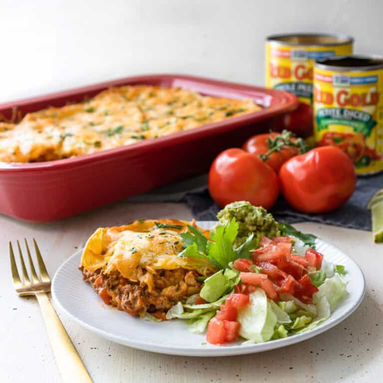 a white plate of enchilada casserole.