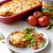 a white plate of enchilada casserole.