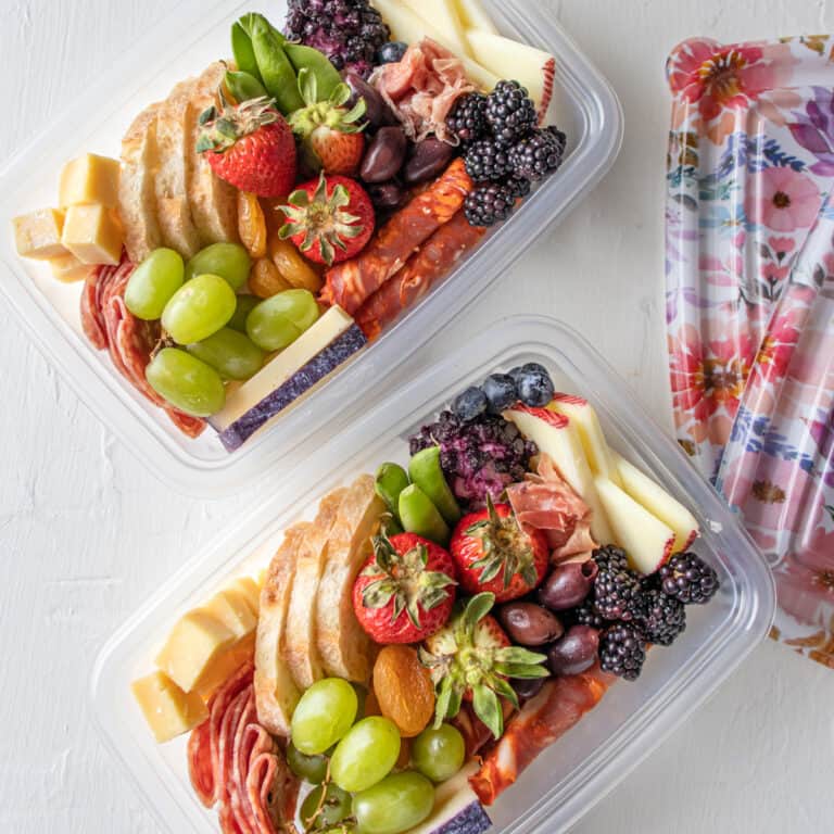 two to go containers with Summer Picnic Charcuterie Board inside them.