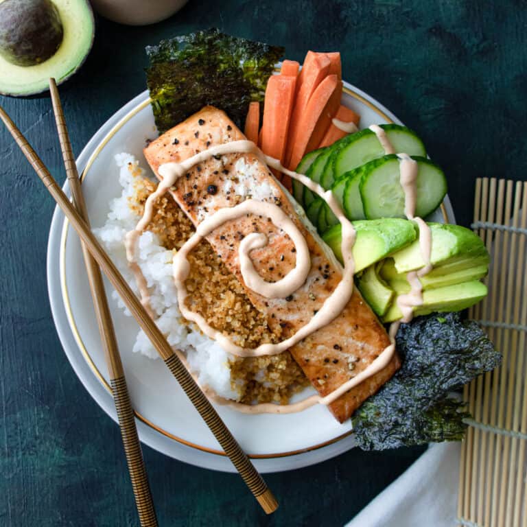 baked salmon sushi bowl with chopsticks.