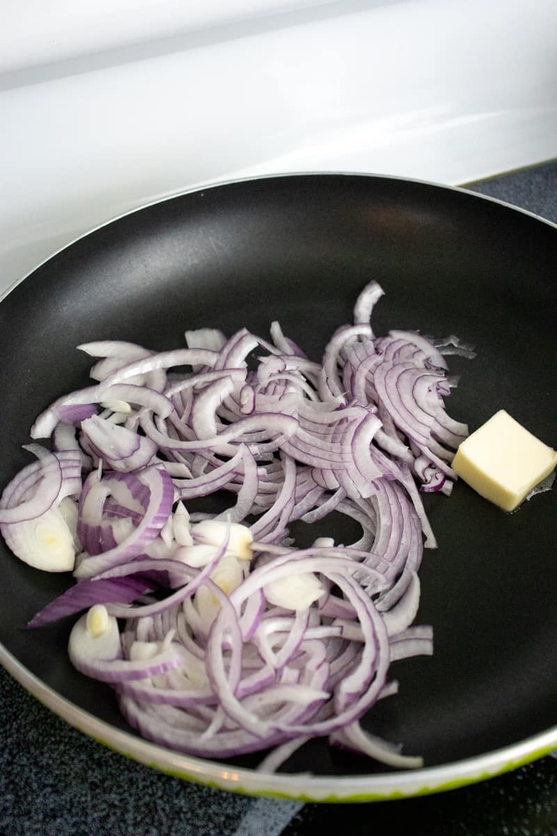 sautéing red onion in a skillet.