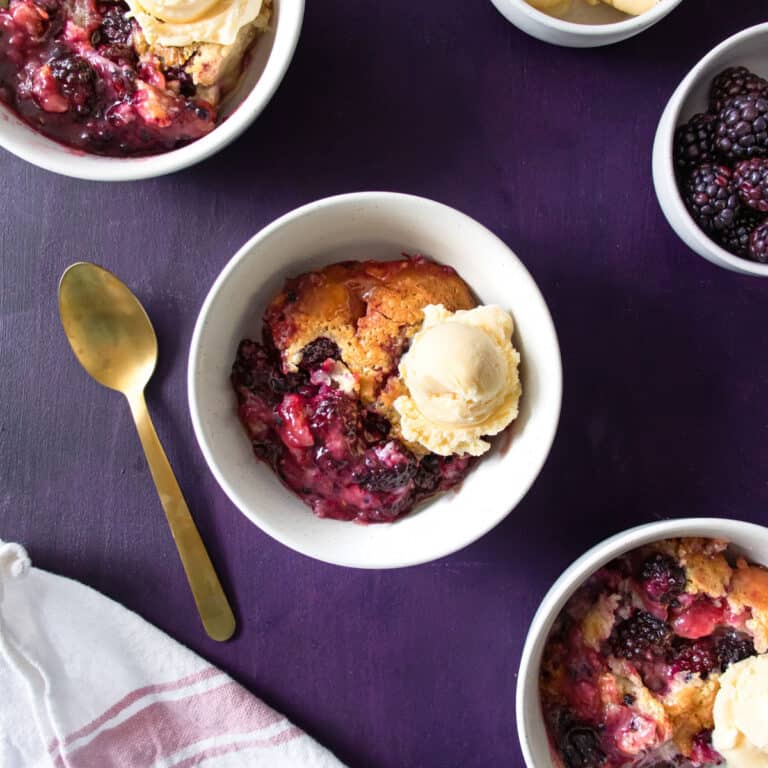 3 bowls of Old Fashioned Southern Blackberry Cobbler with ice cream in them
