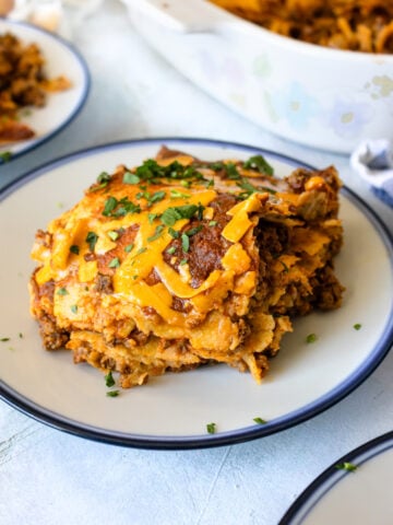 Enchilada casserole on a small blue plate.