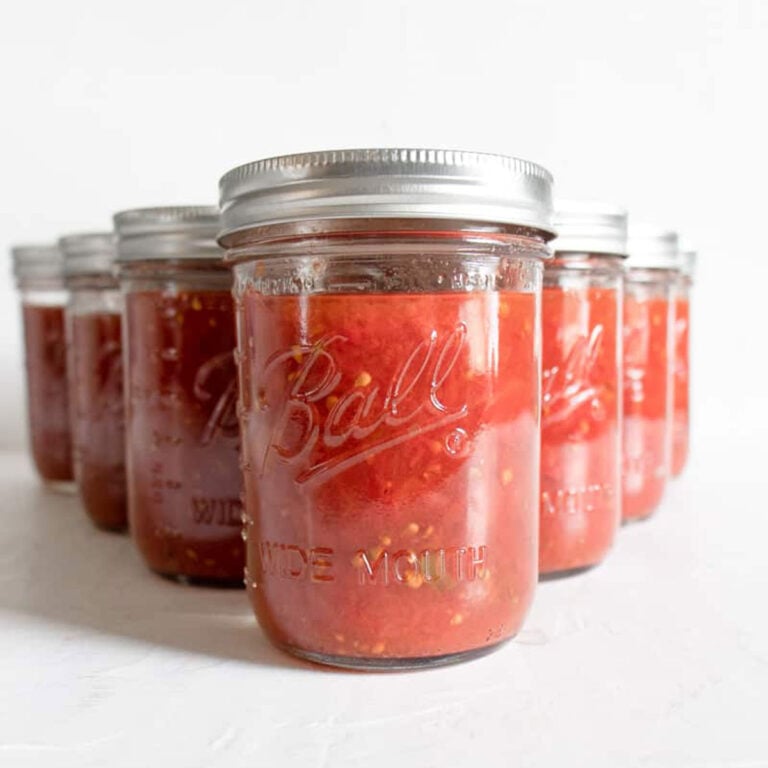 mason jars on a white table for How to Can Tomatoes