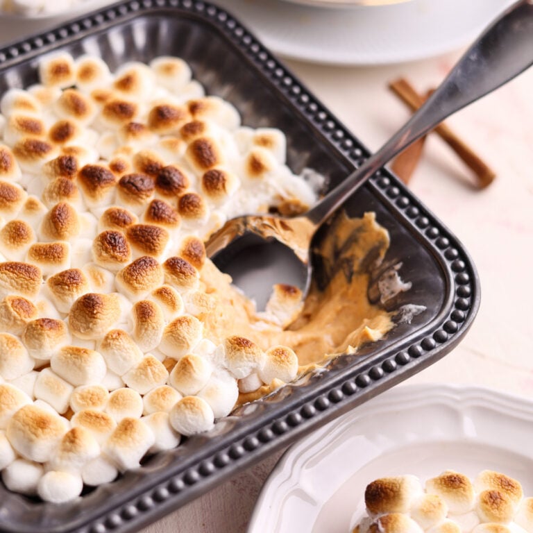 sweet potato dessert dip with mini marshmallows on top and a spoon inside.
