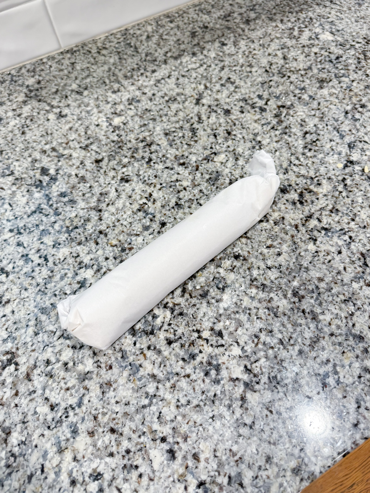 twisting the ends of parchment paper around cookie dough.