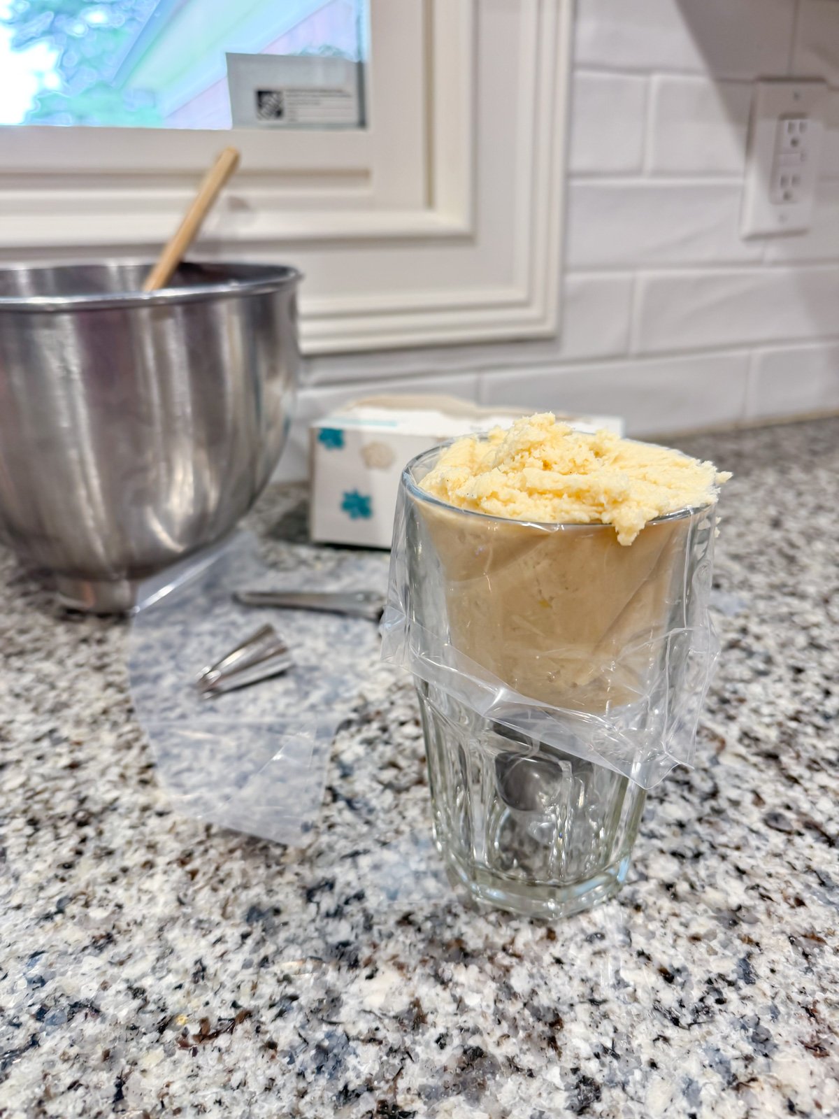 filling a piping bag with cookie dough.