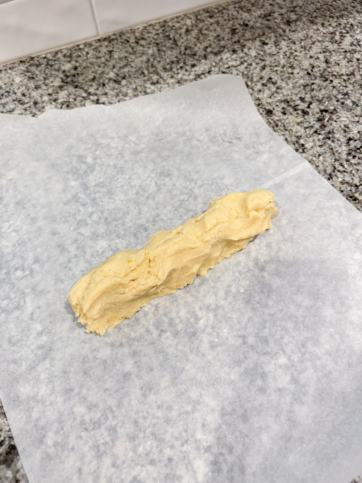 spooning out cookie dough on parchment paper.
