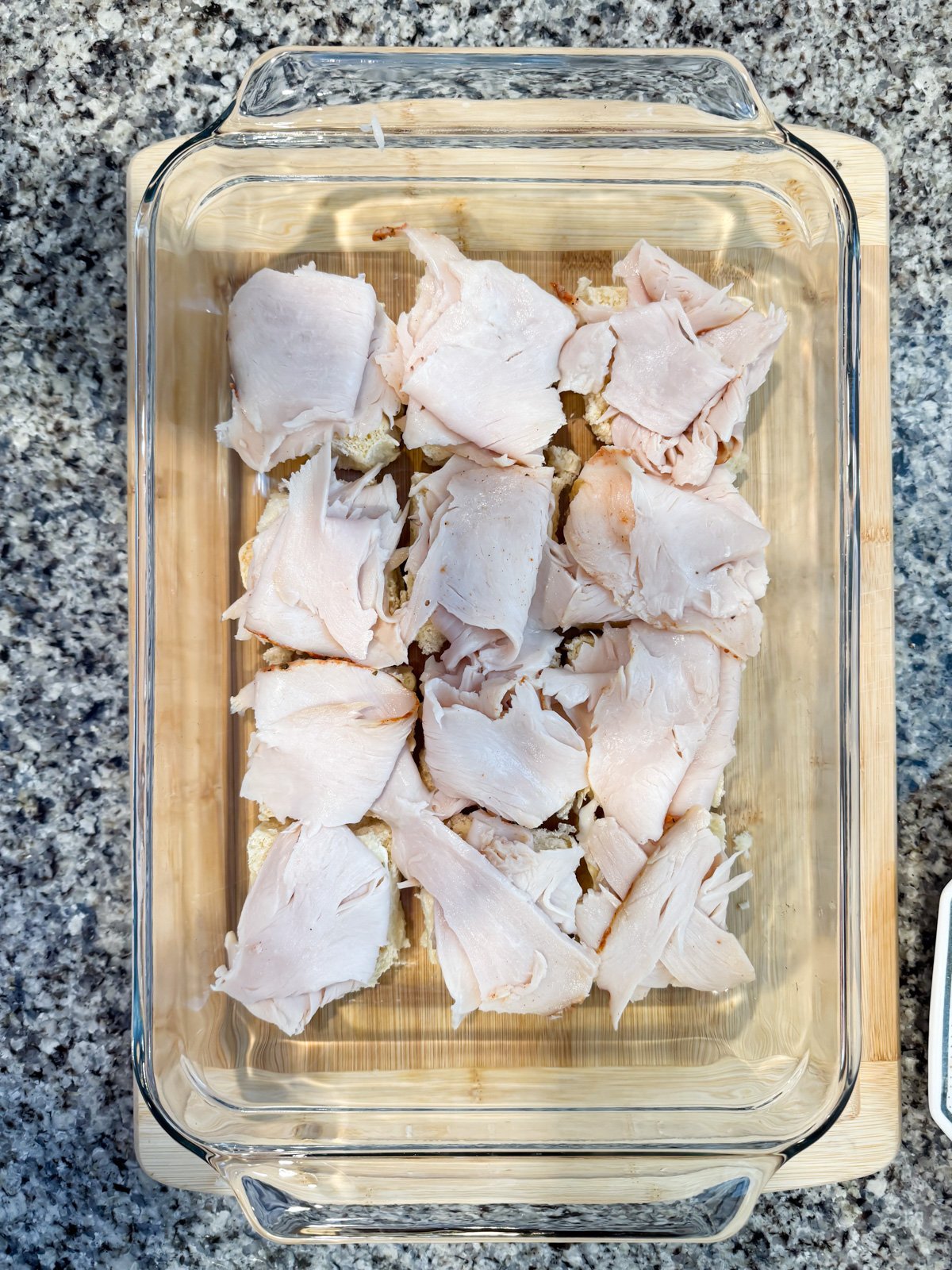 Adding turkey slices on hawaiian rolls.