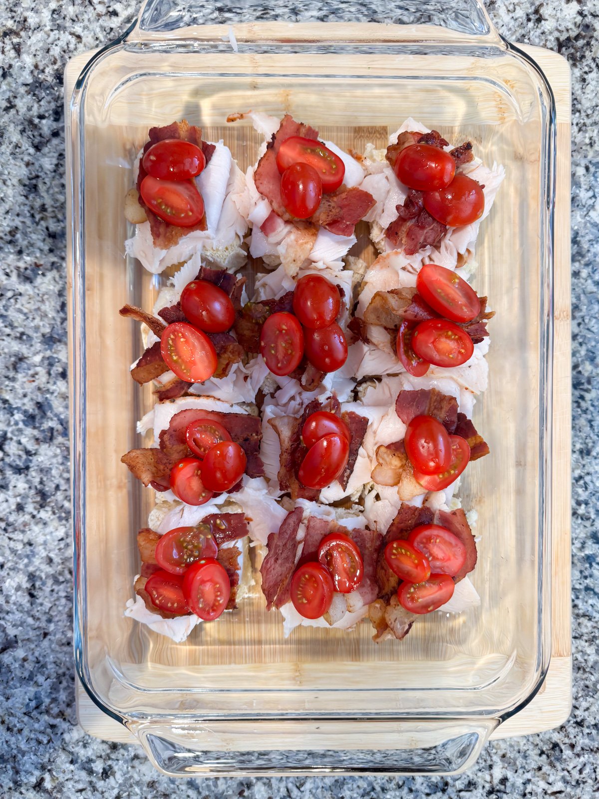 Adding cherry tomatoes to turkey sliders.