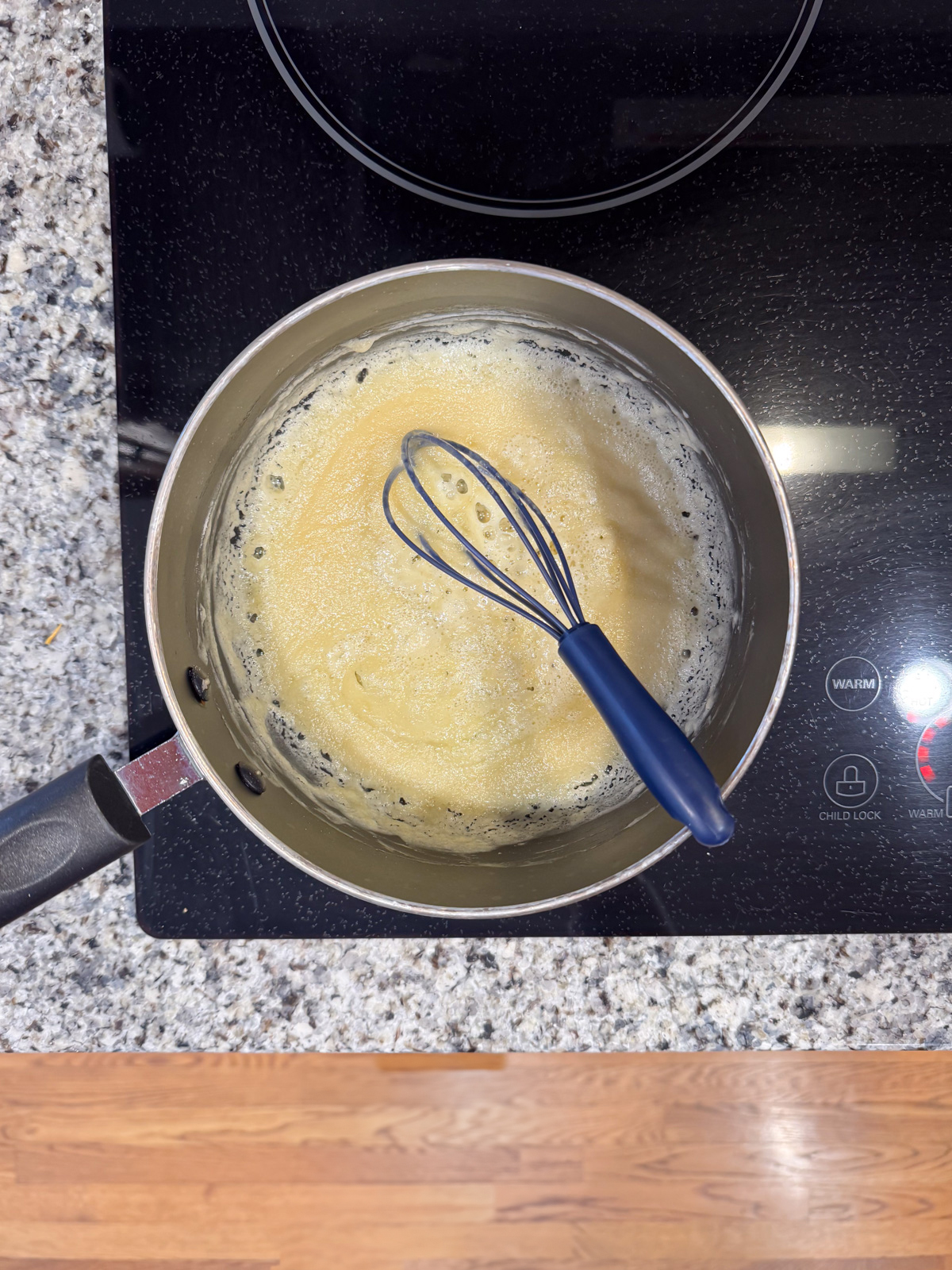 Whisking butter and flour together inside a small sauce pan. 