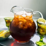 pitcher of sweet tea with 2 glasses in the background