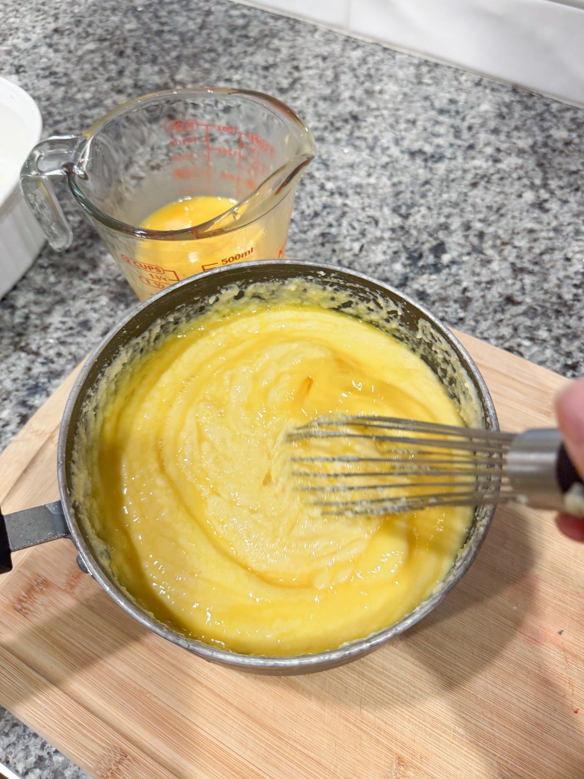 Whisking spoon bread batter in a pot. 