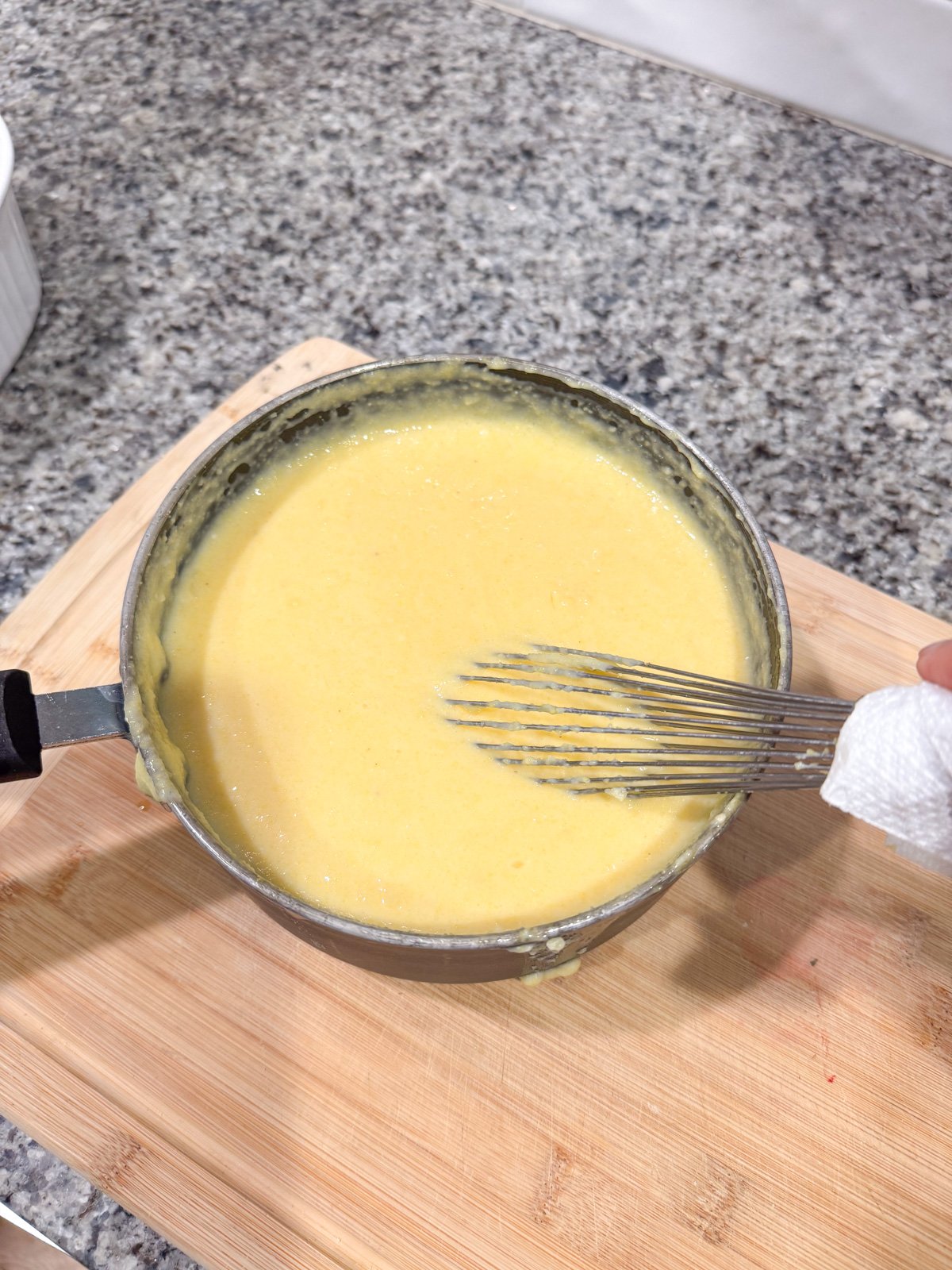 Whisking spoon bread mixture in a pot. 