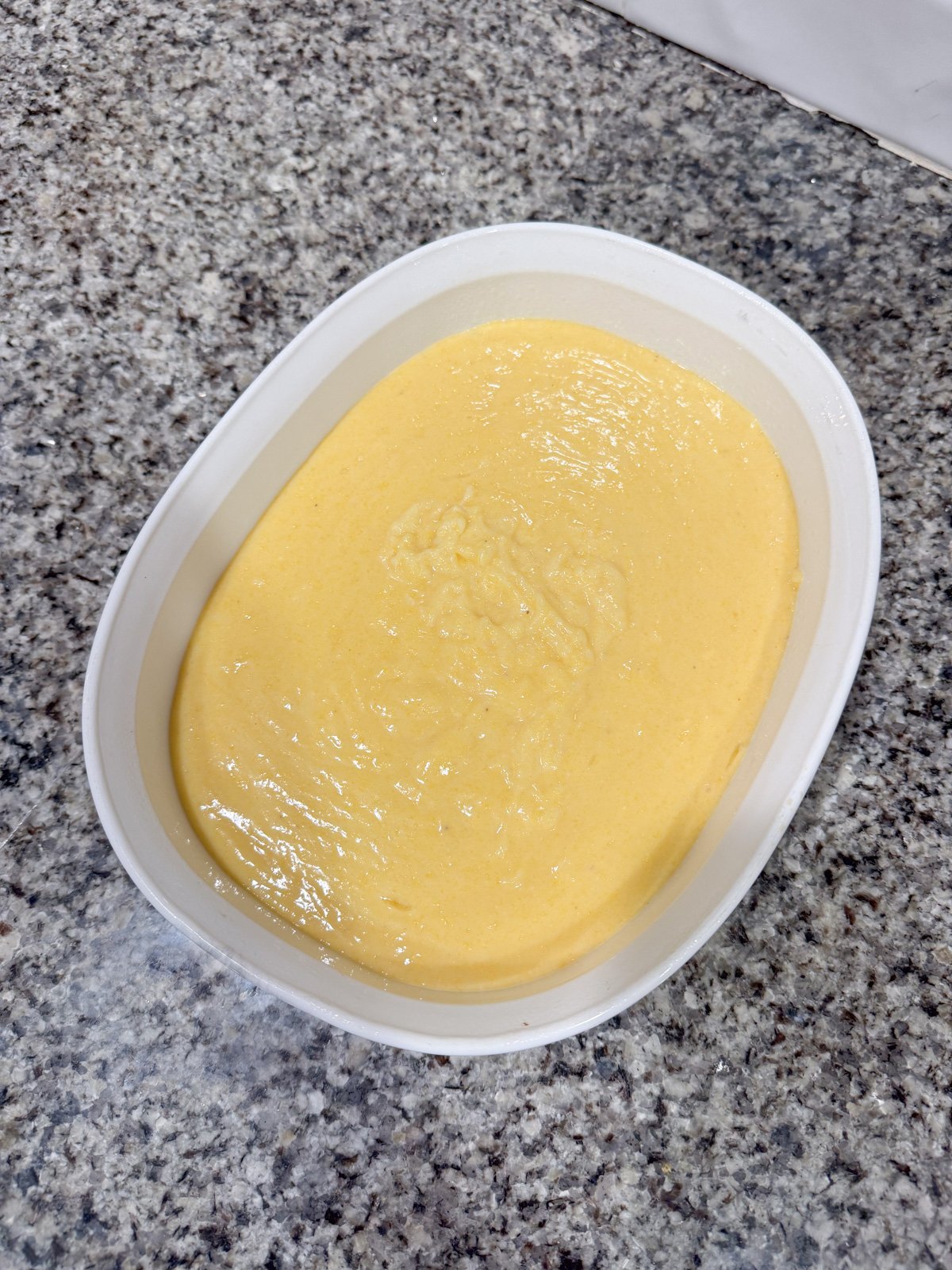 Spoonbread filling in a baking dish before going into the oven. 